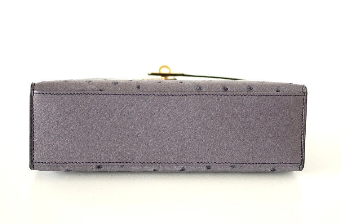 A GRIS ASPHALTE OSTRICH KELLY POCHETTE WITH GOLD HARDWARE